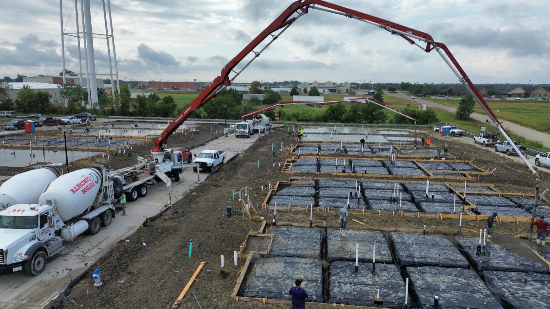 Concrete pump boom over residential foundation pads